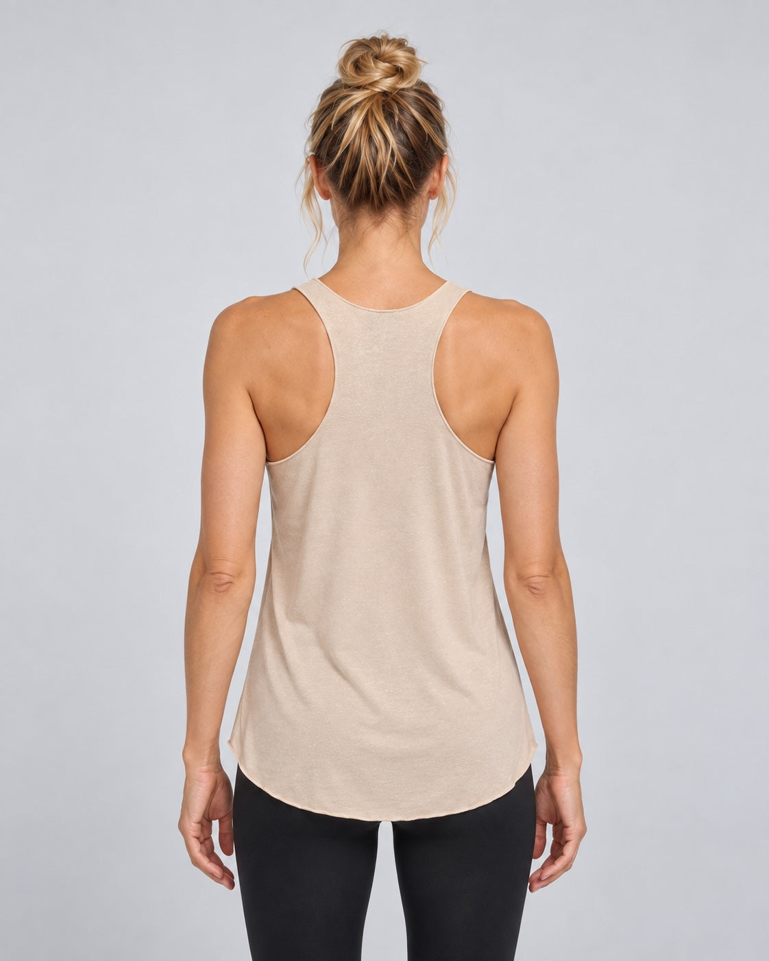 Yoganastix Vanilla Boyfriend Tank on Amy, back view showing racerback and flowing curved hem